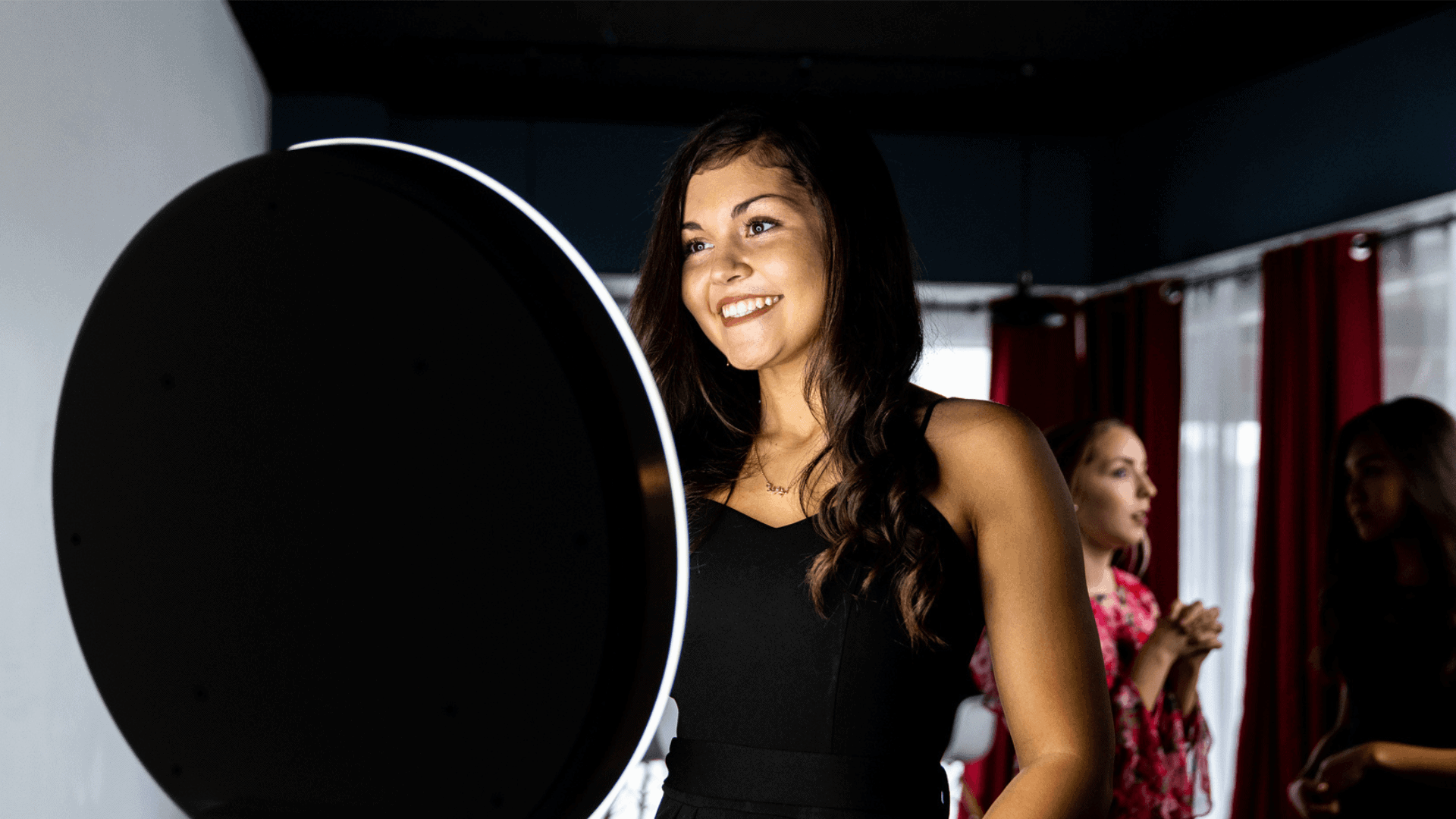 Woman using a digital photo booth at a celebration, showcasing interactive entertainment for weddings, parties, and corporate events.